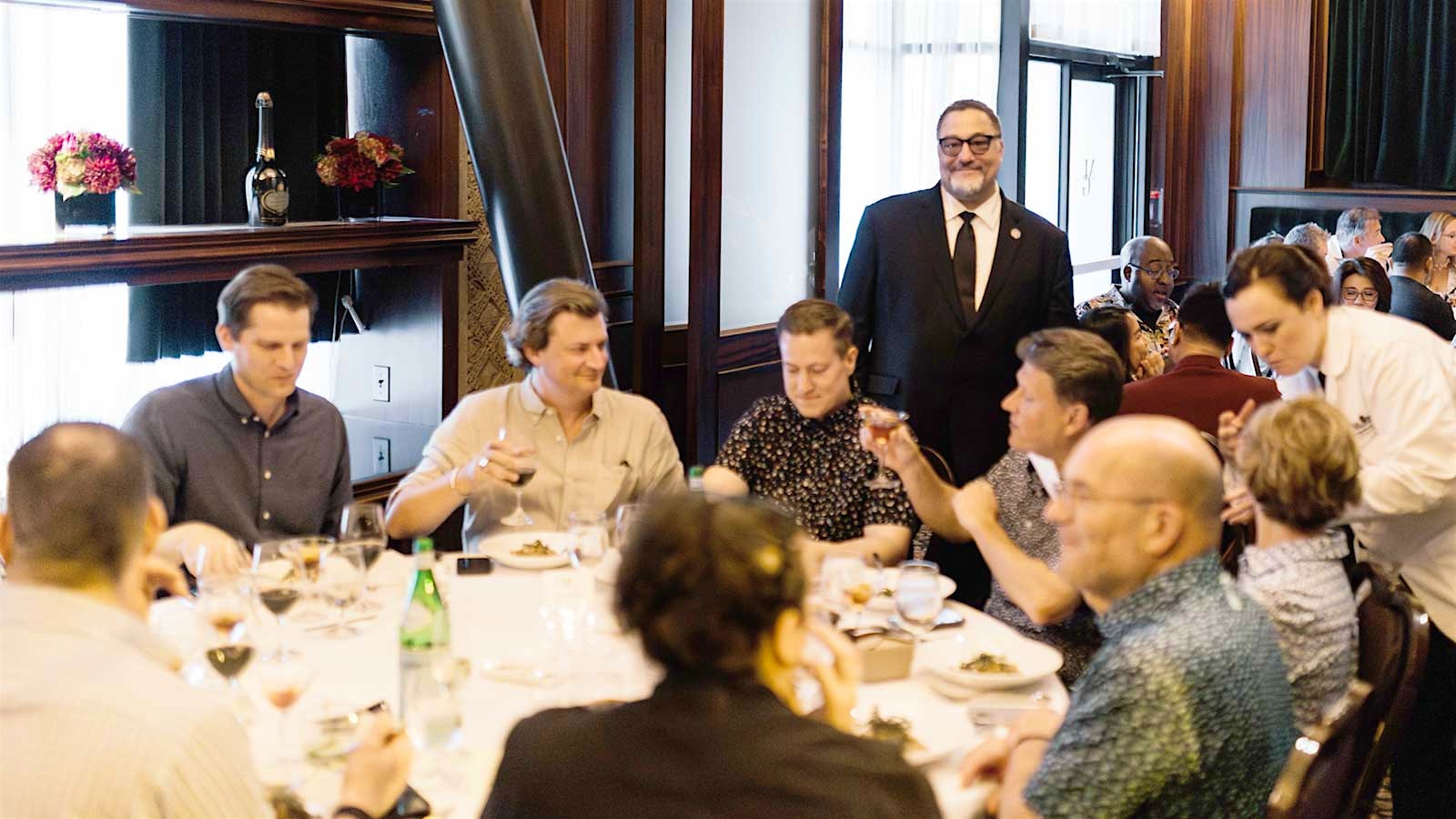 Dining room filled with guests drinking wine at the Metropolitan Grill in Seattle